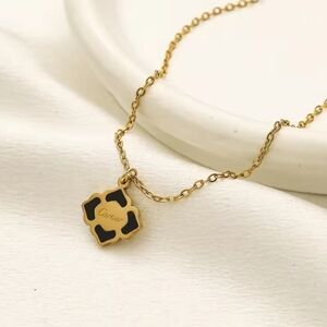 Elegant Gold Necklace with Black Pendant